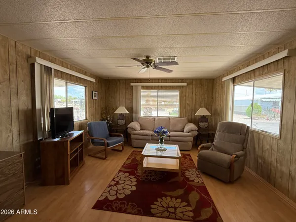 a view of a kitchen with a sink stainless steel appliances furniture cabinets and a window
