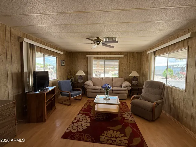 a view of a kitchen with a sink stainless steel appliances furniture cabinets and a window