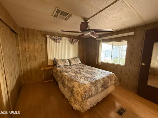 a bed sitting in a bedroom next to a window
