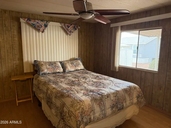 a bedroom with a bed and a window