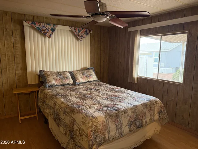 a bedroom with a bed and a window