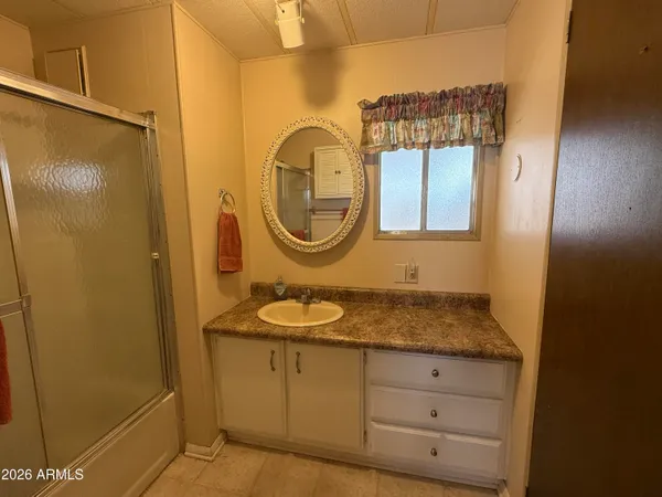 a large kitchen with stainless steel appliances a large counter top a stove and a refrigerator