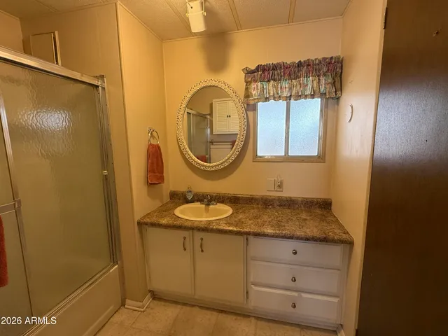 a large kitchen with stainless steel appliances a large counter top a stove and a refrigerator