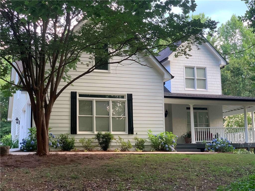 1490 Avery Road Canton, GA 30115 - Photo 1 of 1 a front view of a house with a yard and potted plants