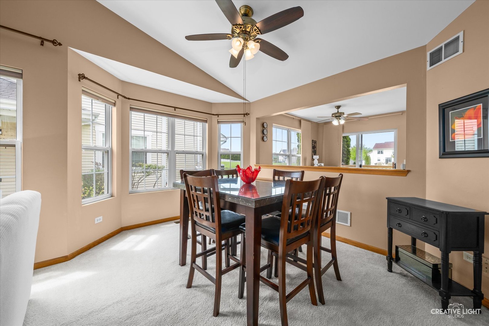 645 Chestnut Ridge Minooka, IL 60447 - Photo 4 of 20 a view of a dining room with furniture and a large window