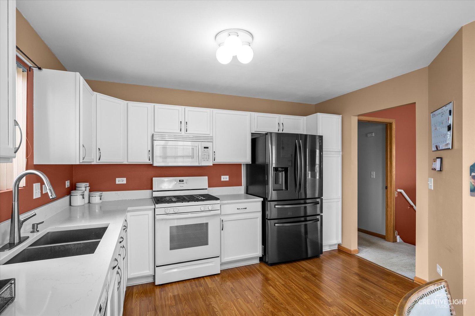 645 Chestnut Ridge Minooka, IL 60447 - Photo 6 of 20 a kitchen with a refrigerator stove and sink