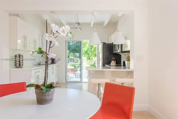 a living room with furniture flowerpot and a window