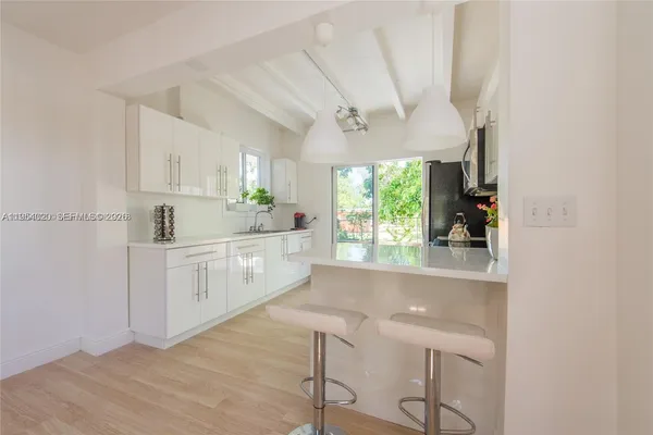 a kitchen with a sink cabinets and window