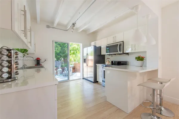 a kitchen with a sink cabinets and wooden floor