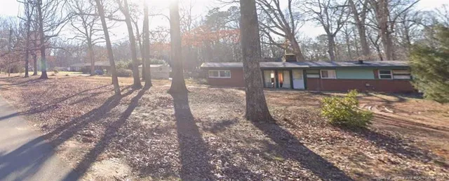 a view of a yard with large trees