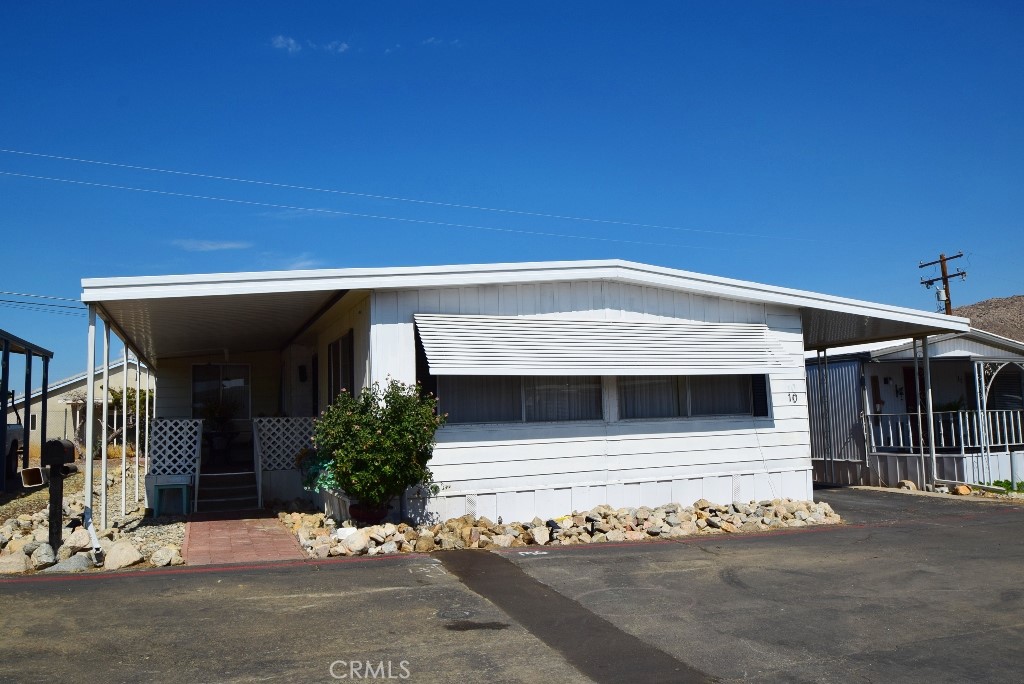7425 Church Street, Unit 10 Yucca Valley, CA 92284 - Photo 2 of 24 a view of a house with a garage