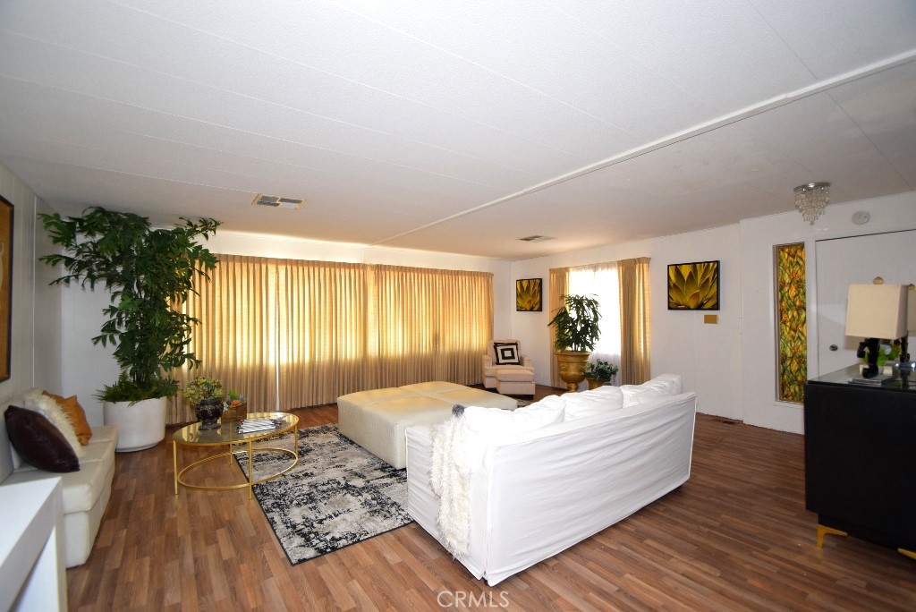 7425 Church Street, Unit 10 Yucca Valley, CA 92284 - Photo 4 of 24 a large bedroom with a bed and wooden floor