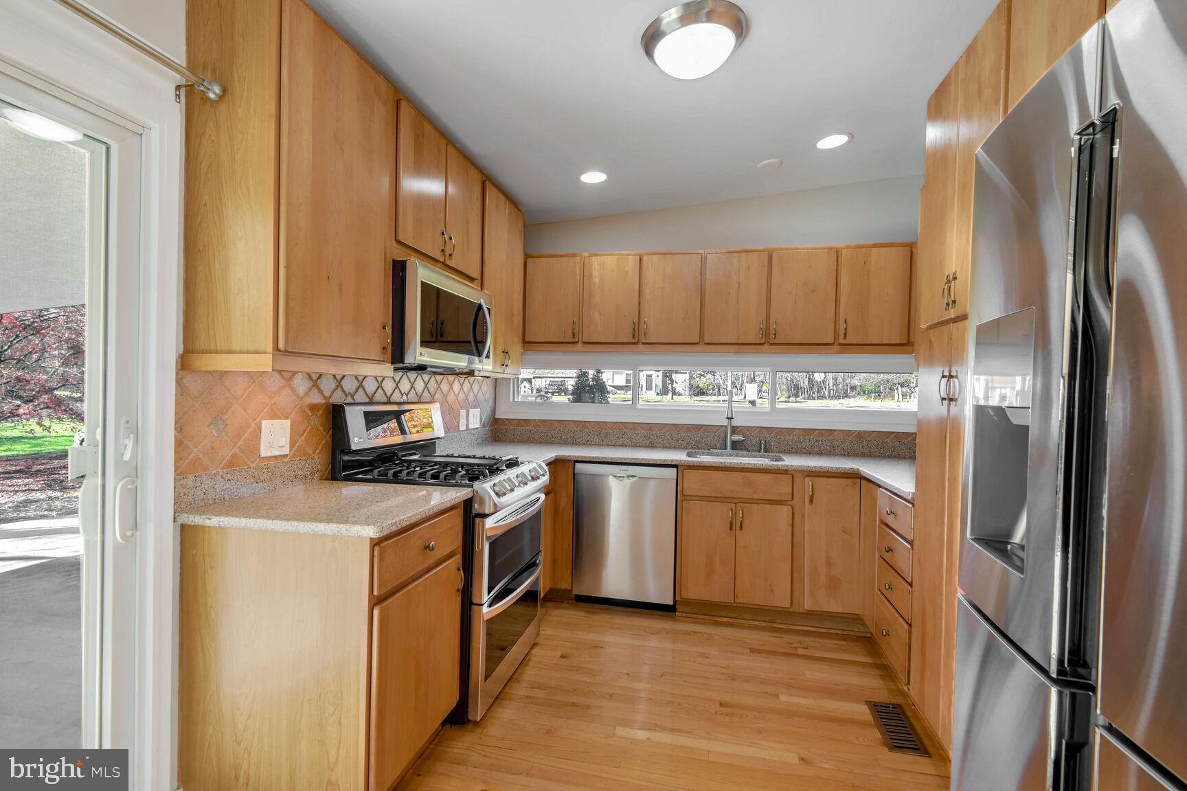 14645 Good Hope Road Silver Spring, MD 20905 - Photo 10 of 26 Modern kitchen with warm wood tones.