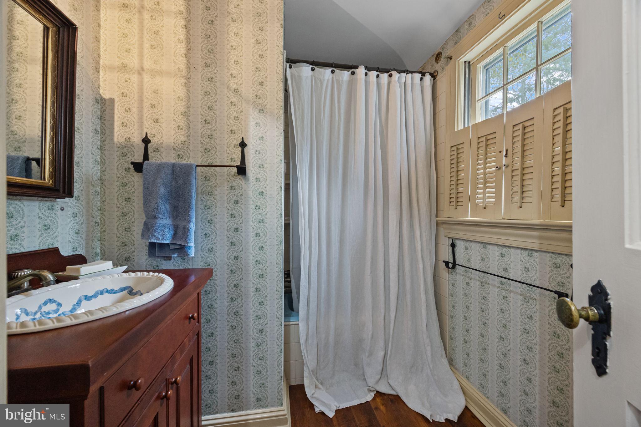 1217 Yardley Morrisville Road Yardley, PA 19067 - Photo 12 of 57 a bathroom with a granite countertop sink a mirror and shower
