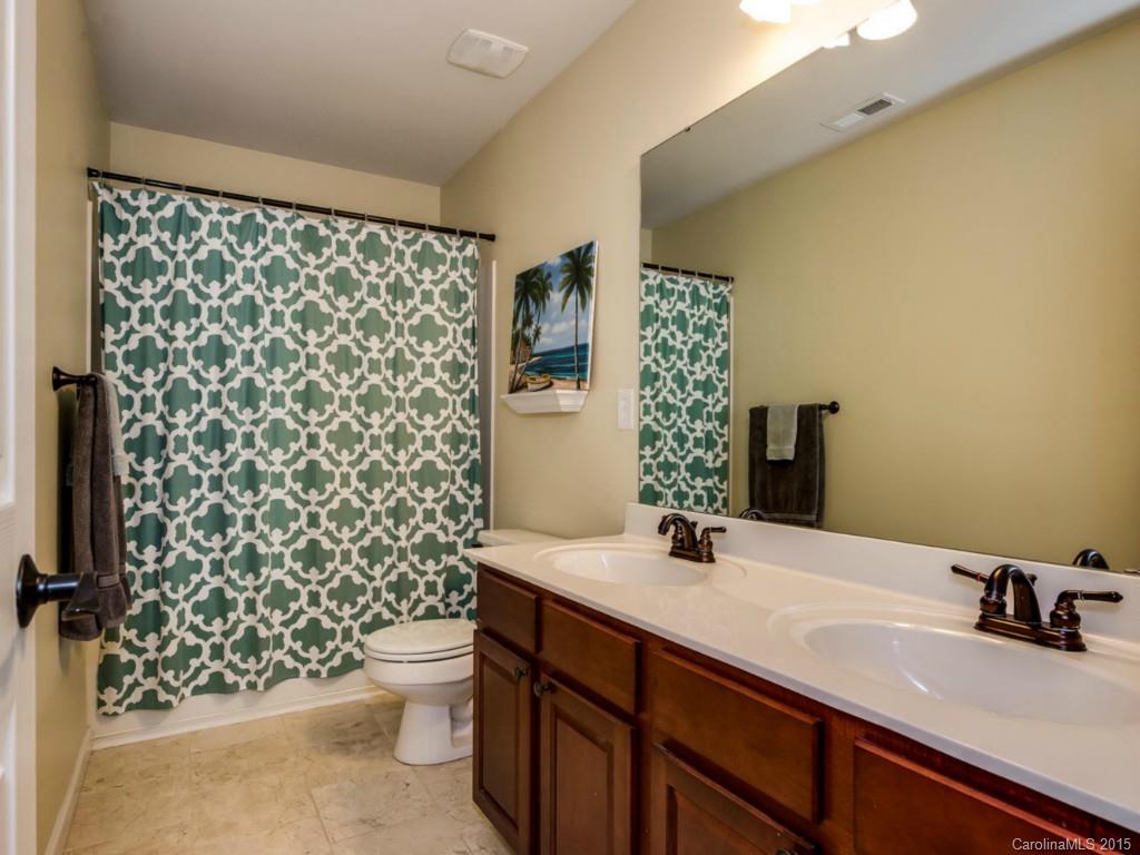 306 Allspice Road Fort Mill, SC 29708 - Photo 12 of 24 a bathroom with a sink a toilet and shower curtain
