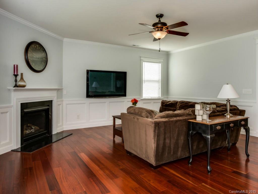 306 Allspice Road Fort Mill, SC 29708 - Photo 18 of 24 a living room with furniture a fireplace and a flat screen tv