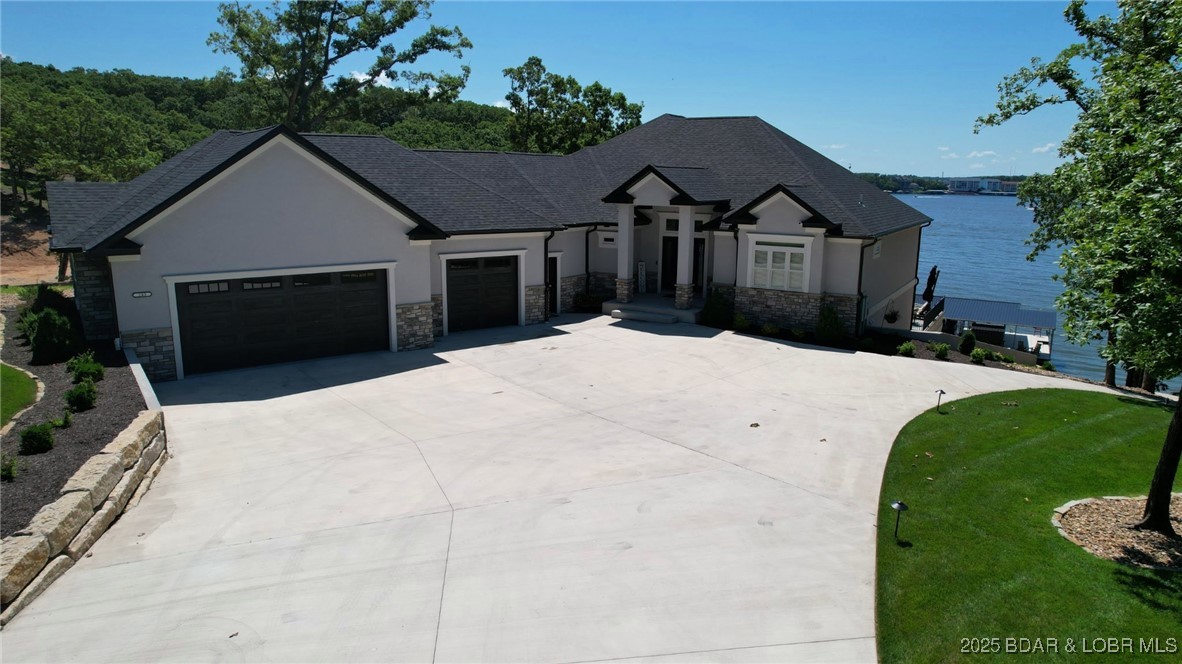 243 East Villages Estates Road Sunrise Beach, MO 65079 - Photo 5 of 60 Front View of Home with LEVEL driveway