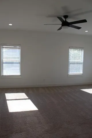 a view of an empty room and a window