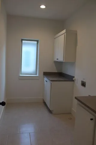 a utility room with a sink washer and dryer