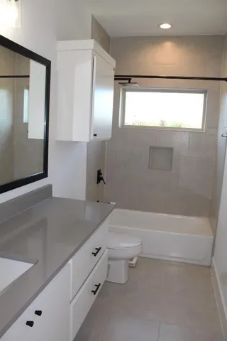a bathroom with a toilet a sink and bathtub