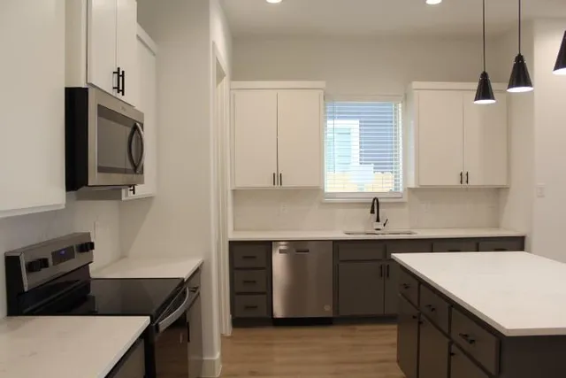 a kitchen that has a sink and a stove in it