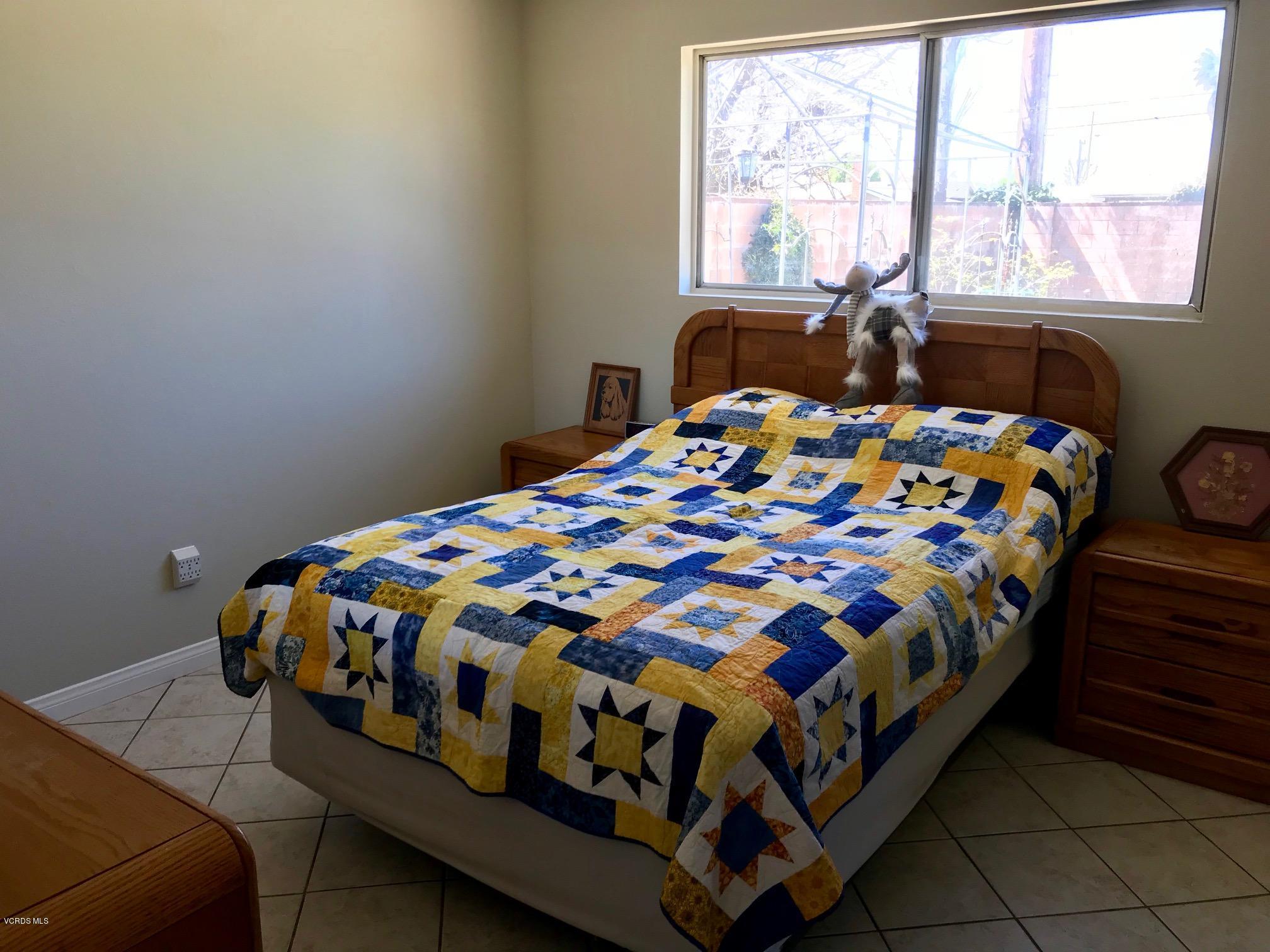 2227 Ralston Street Simi Valley, CA 93063 - Photo 17 of 35 a bedroom with a bed next to a window
