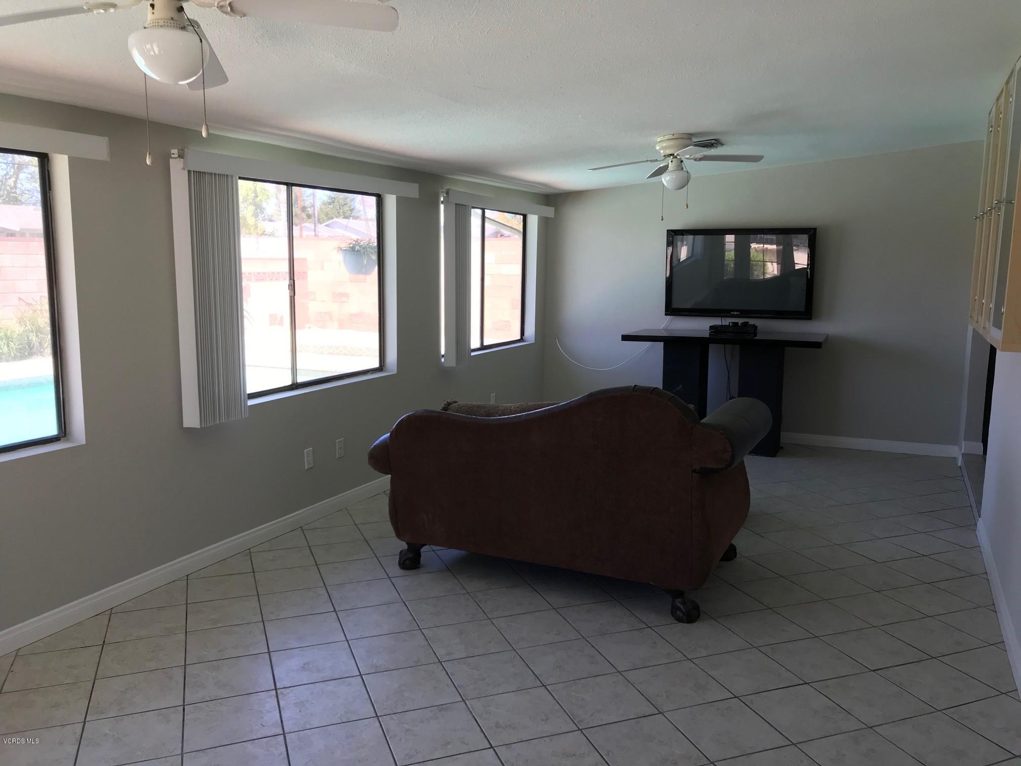 2227 Ralston Street Simi Valley, CA 93063 - Photo 31 of 35 a living room with furniture and a flat screen tv