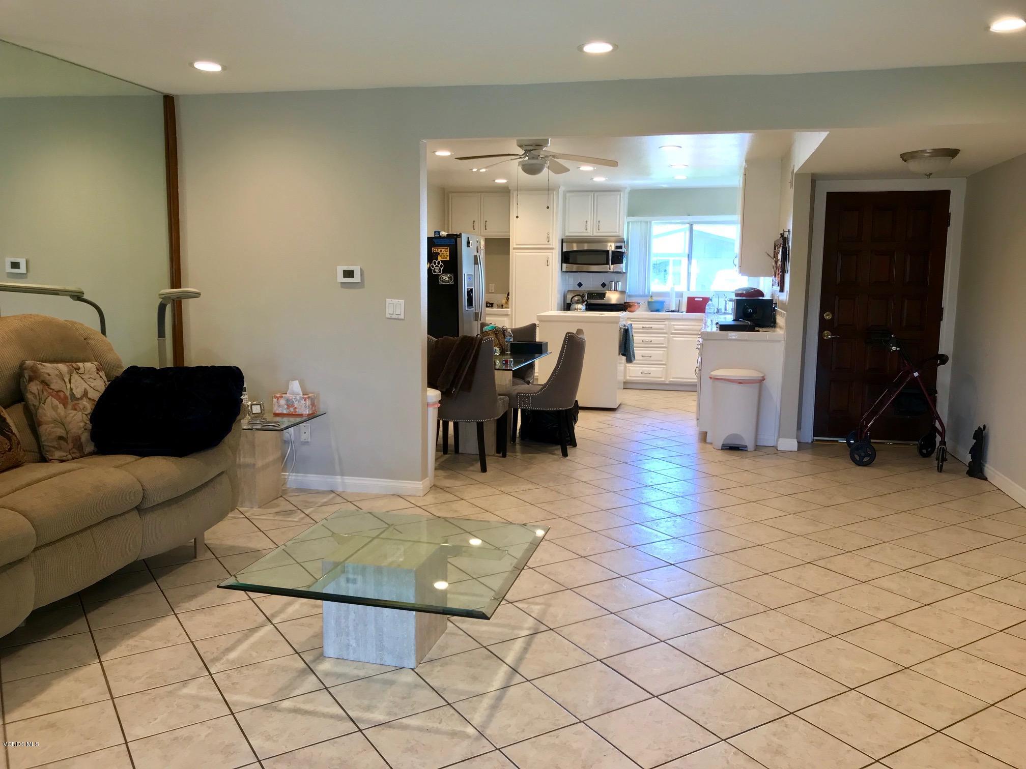 2227 Ralston Street Simi Valley, CA 93063 - Photo 5 of 35 a living room with couches and kitchen view with wooden floor