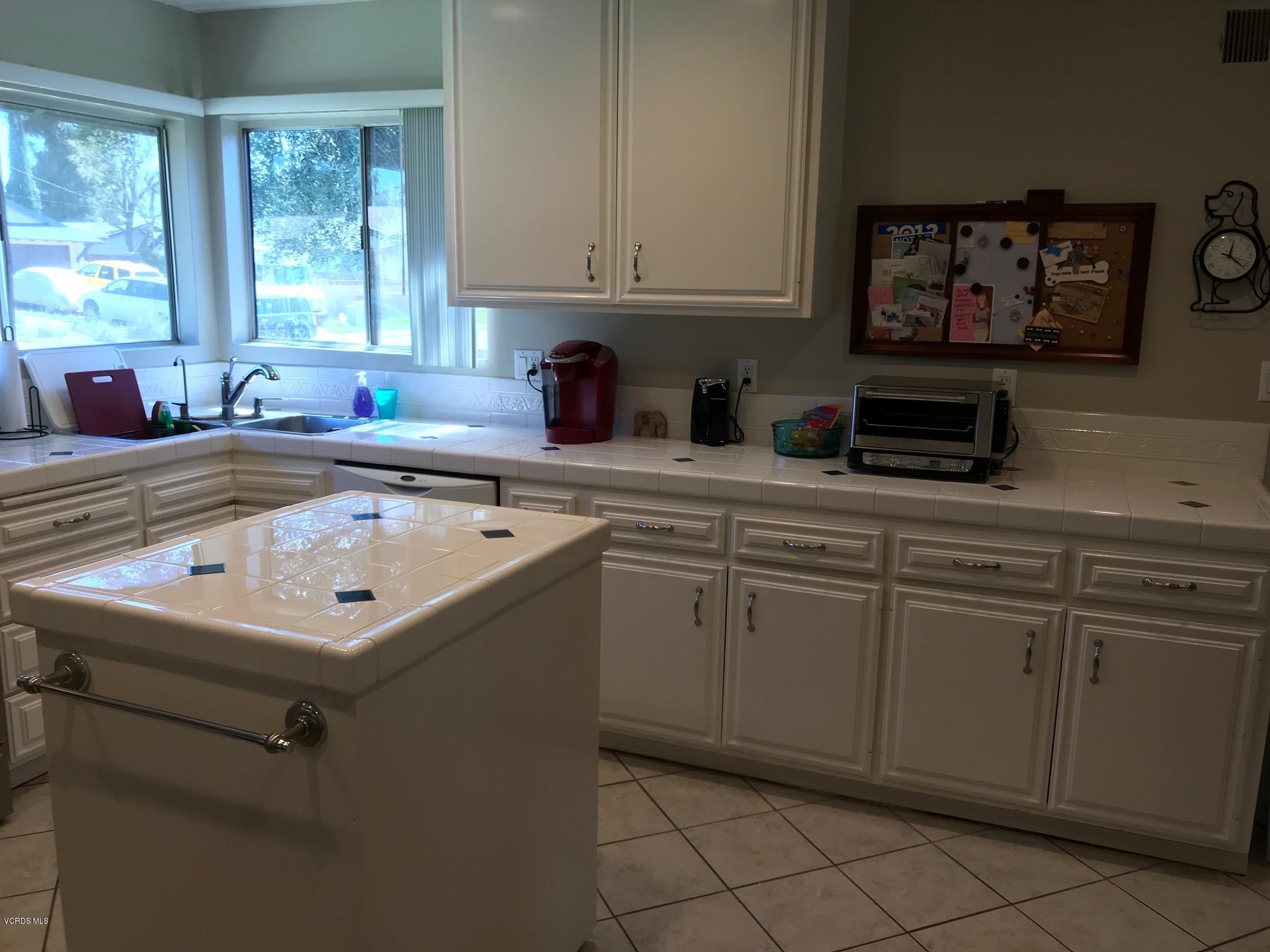 2227 Ralston Street Simi Valley, CA 93063 - Photo 7 of 35 a kitchen with a sink window and cabinets
