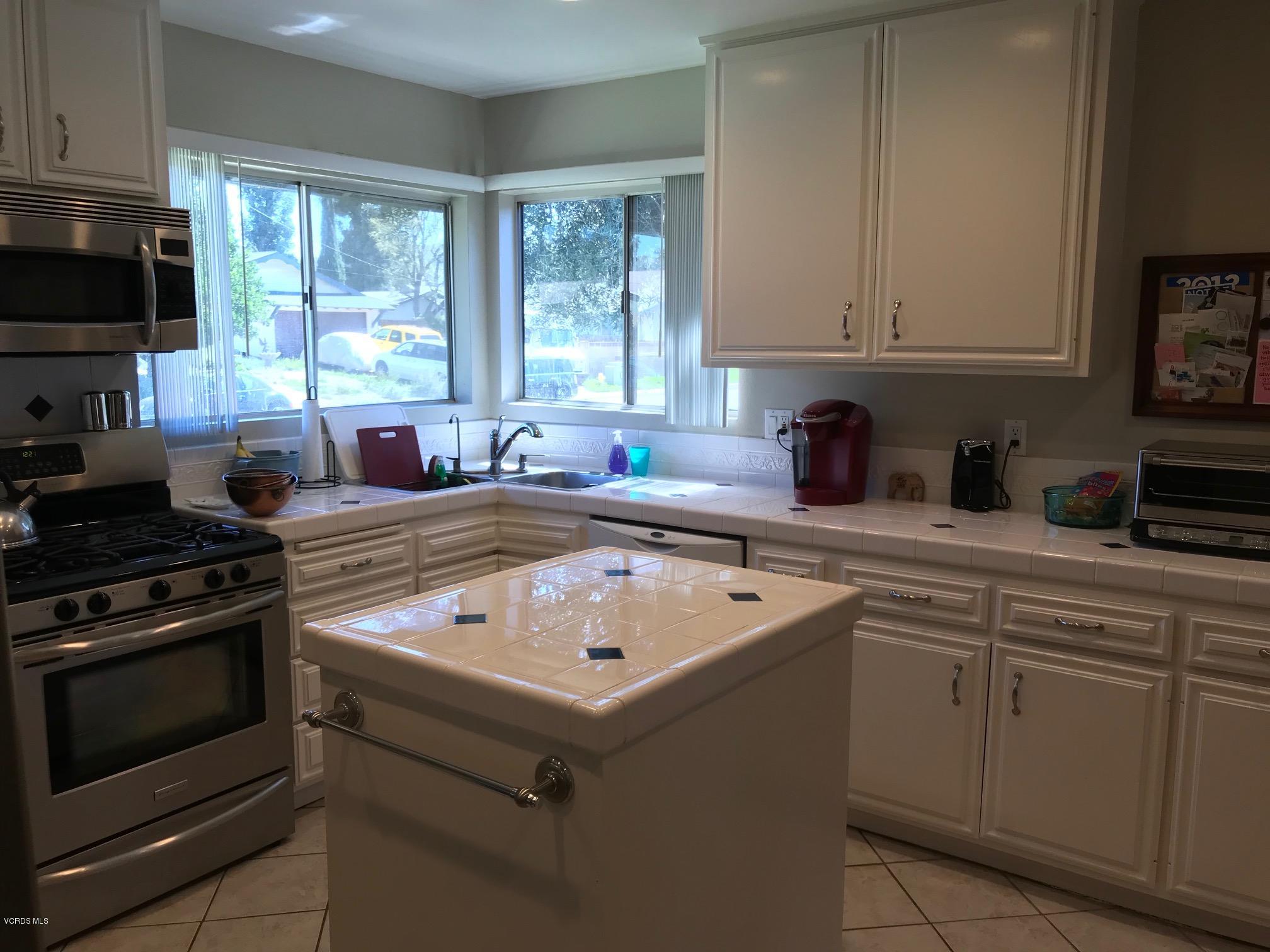 2227 Ralston Street Simi Valley, CA 93063 - Photo 8 of 35 a kitchen with a sink stove and microwave