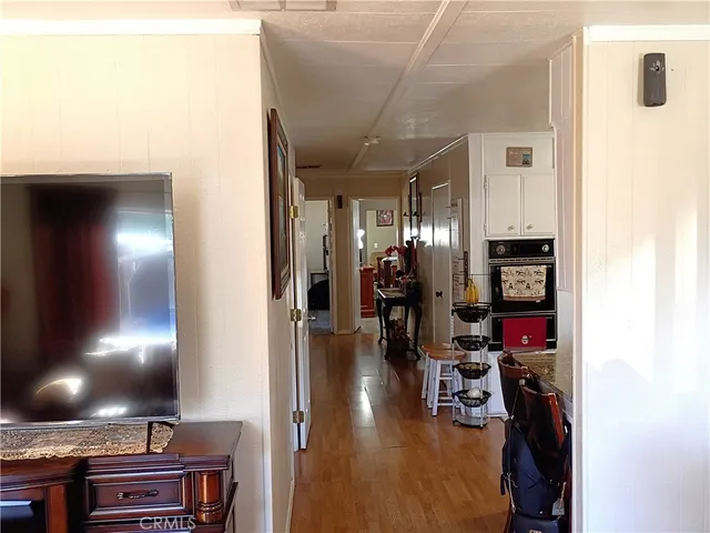 a view of a entryway with workspace and wooden floor