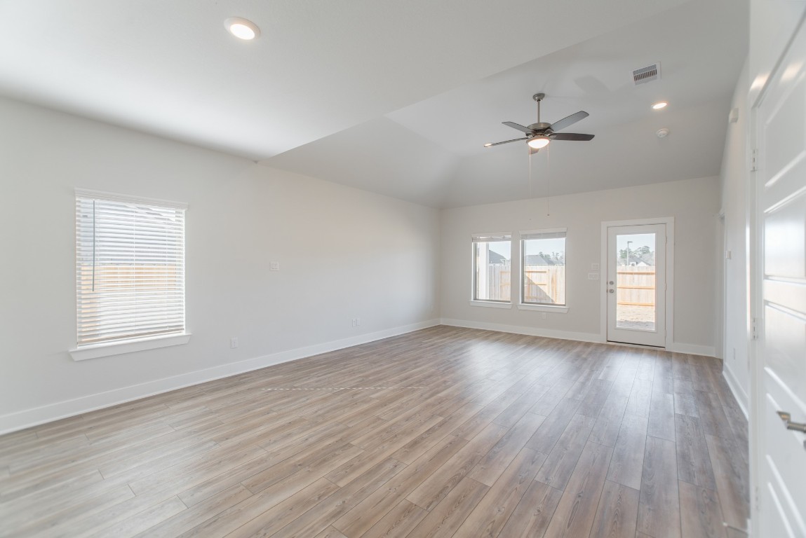 10627 Whitejacket Conroe, TX 77385 - Photo 18 of 46 a view of empty room with wooden floor and fan