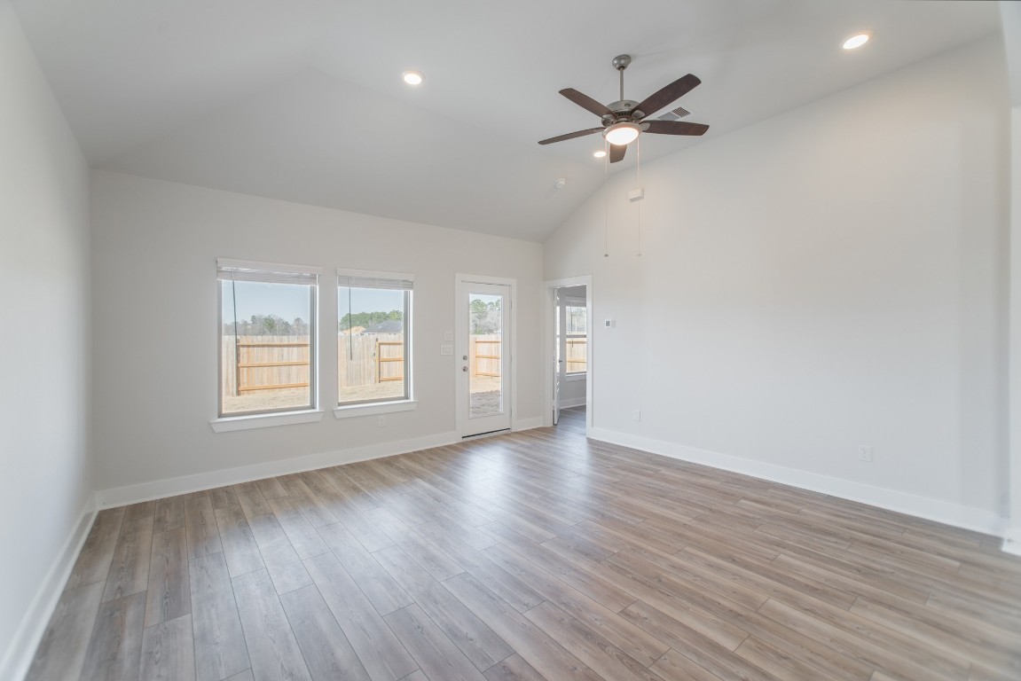 10627 Whitejacket Conroe, TX 77385 - Photo 19 of 46 a view of an empty room with wooden floor and a window