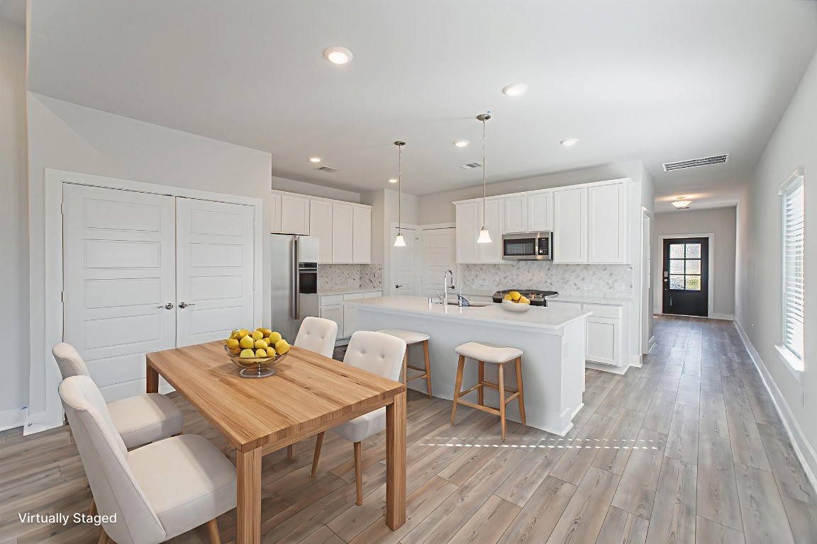 10627 Whitejacket Conroe, TX 77385 - Photo 2 of 46 a large white kitchen with lots of counter space and refrigerator
