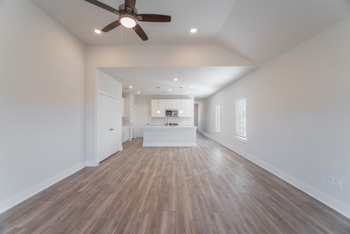 10627 Whitejacket Conroe, TX 77385 - Photo 21 of 46 a view of a hallway with wooden floor and a kitchen
