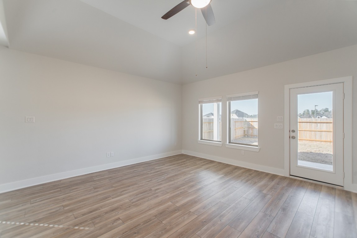 10627 Whitejacket Conroe, TX 77385 - Photo 23 of 46 an empty room with wooden floor and windows