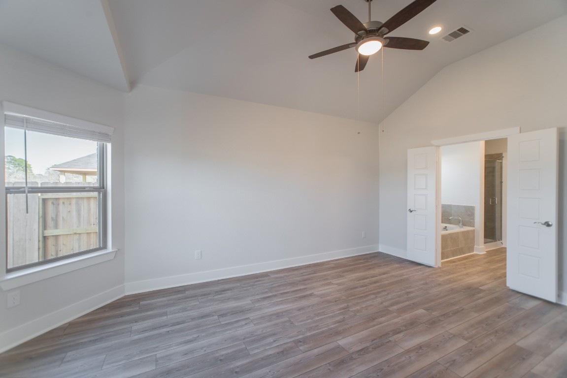 10627 Whitejacket Conroe, TX 77385 - Photo 24 of 46 wooden floor in an empty room with a window