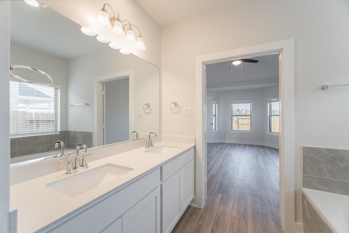 10627 Whitejacket Conroe, TX 77385 - Photo 28 of 46 a bathroom with a double vanity sink and a mirror