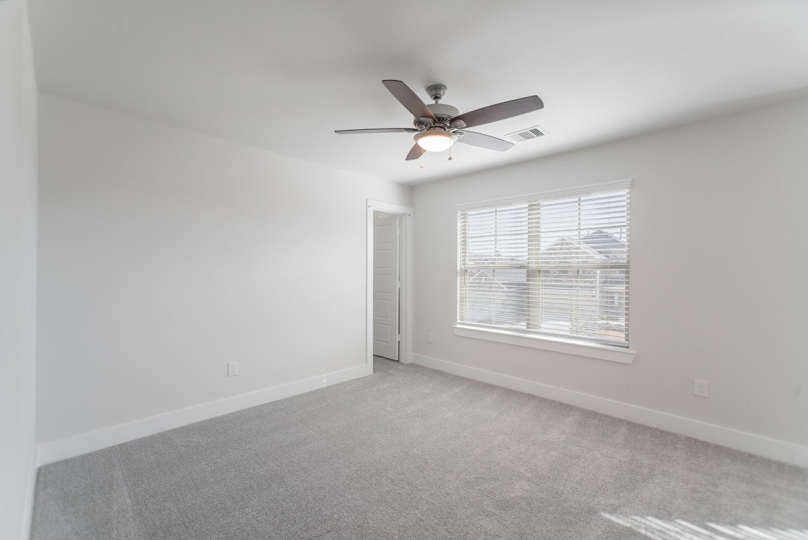 10627 Whitejacket Conroe, TX 77385 - Photo 41 of 46 an empty room with a window and a fan
