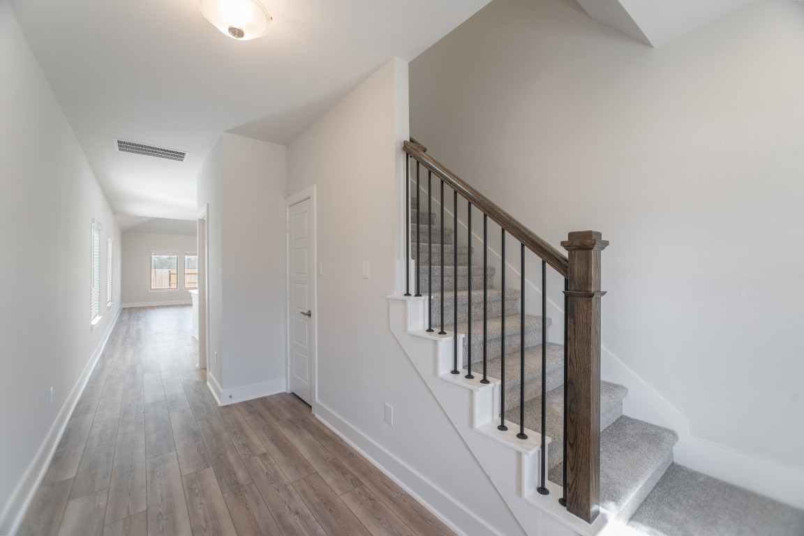 10627 Whitejacket Conroe, TX 77385 - Photo 7 of 46 a view of a hallway with wooden floor and entryway