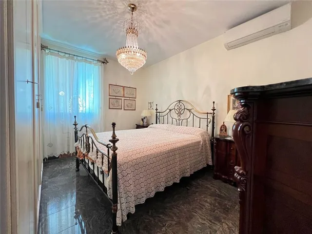 a bed room with a bed and a chandelier