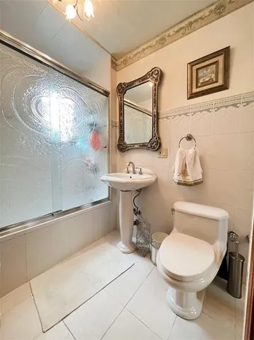 a bathroom with a sink mirror vanity and toilet