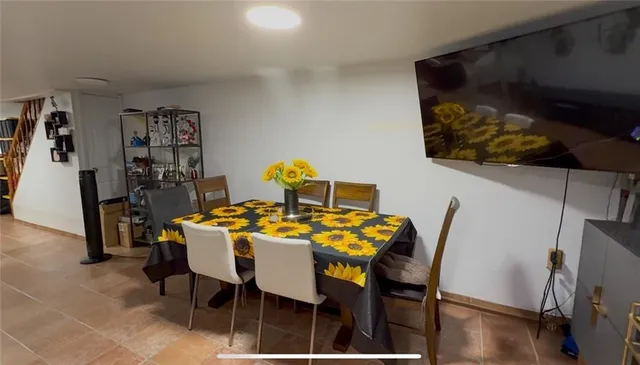 a dining room with furniture and wooden floor