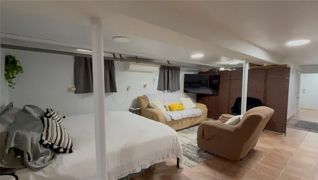 a bed room with furniture and a flat screen tv