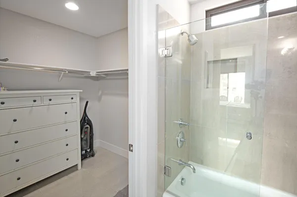 a en suite bathroom with a double vanity sink a mirror and a shower
