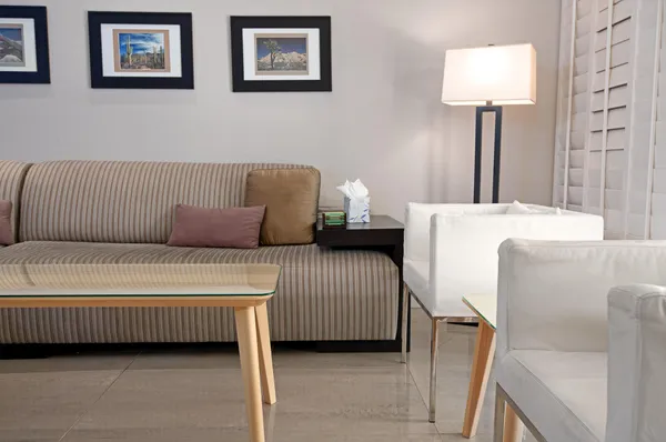 a living room with furniture flat screen tv and a couch