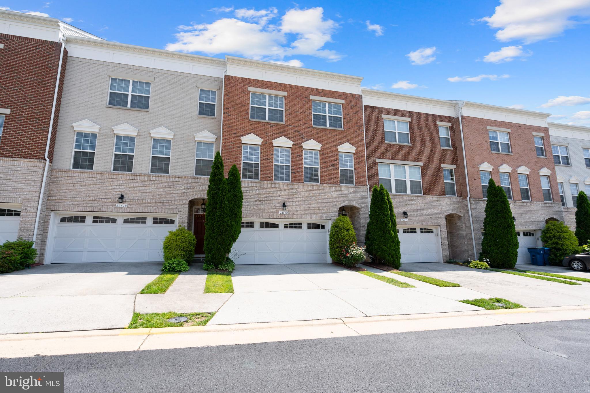 22672 Flowing Spring Square Brambleton, VA 20148 - Photo 1 of 35 a front view of a building with a garden
