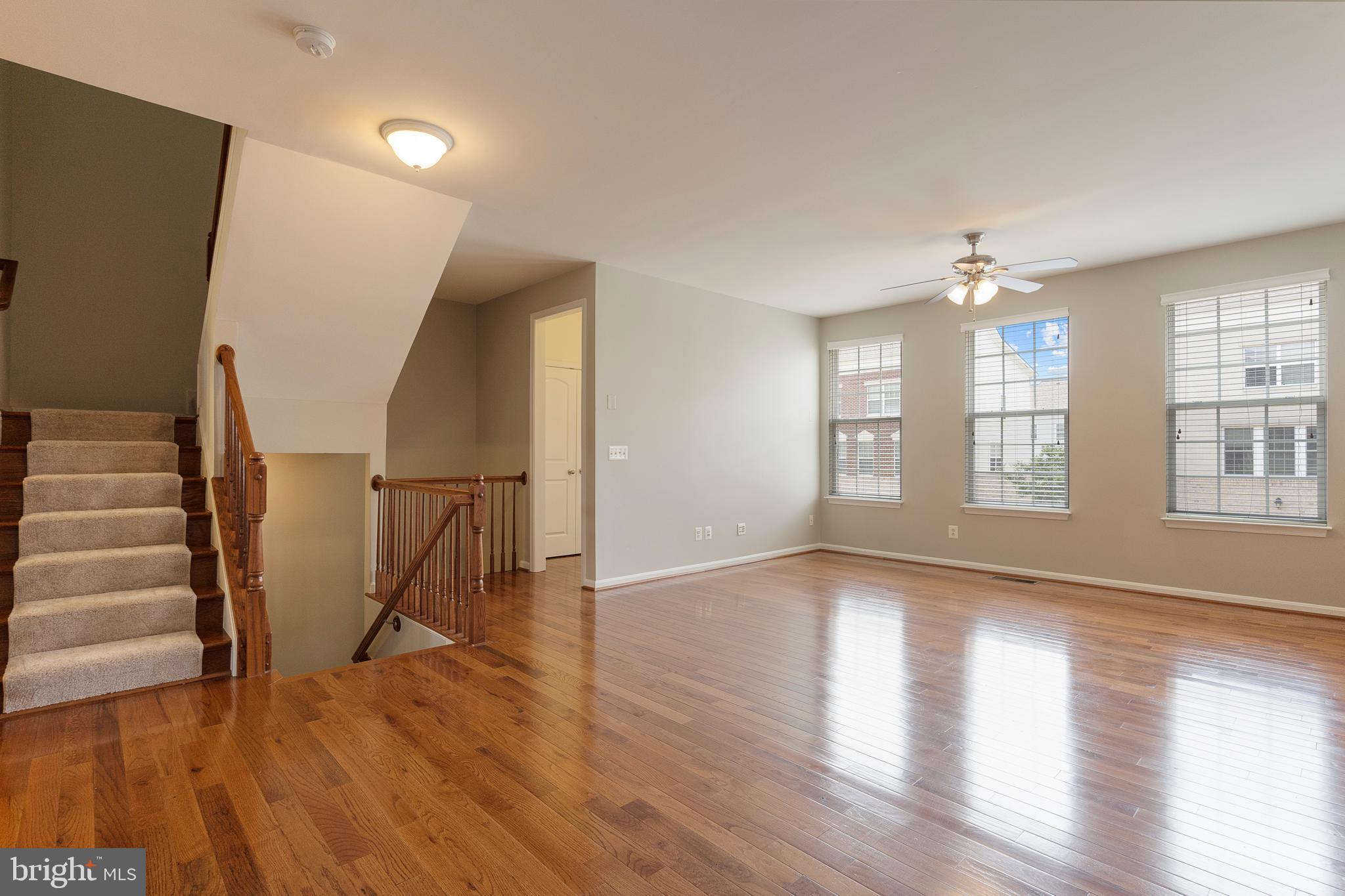 22672 Flowing Spring Square Brambleton, VA 20148 - Photo 12 of 35 a view of an empty room with wooden floor and a window