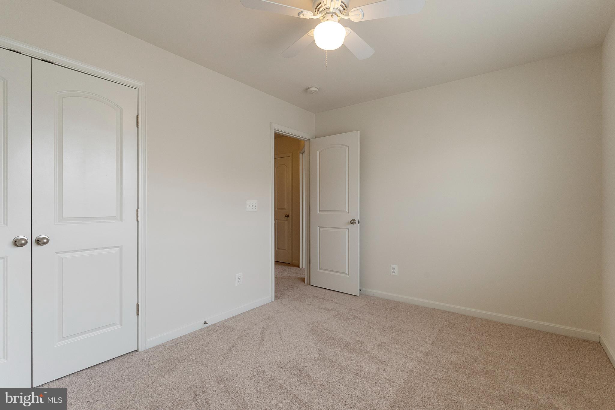 22672 Flowing Spring Square Brambleton, VA 20148 - Photo 16 of 35 a view of an empty room with a chandelier fan
