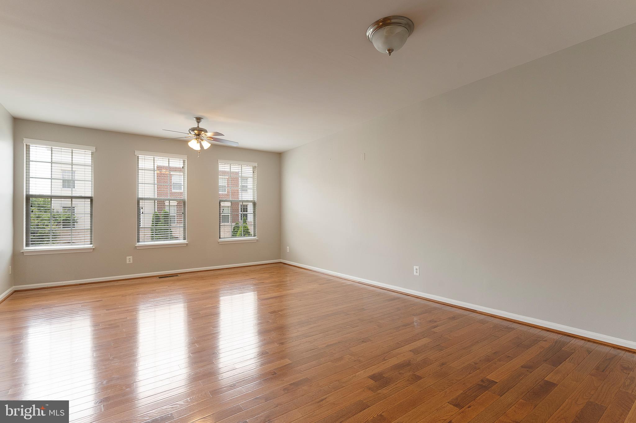 22672 Flowing Spring Square Brambleton, VA 20148 - Photo 3 of 35 wooden floor in an empty room with a window